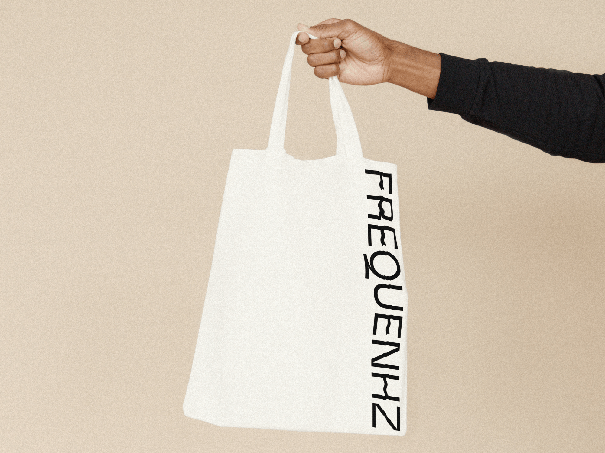 frequenhz logotype in a white shopping bag held by hand
